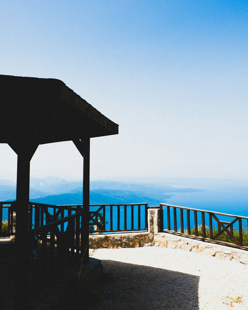 brown wooden gazebo on white concrete dock during daytime