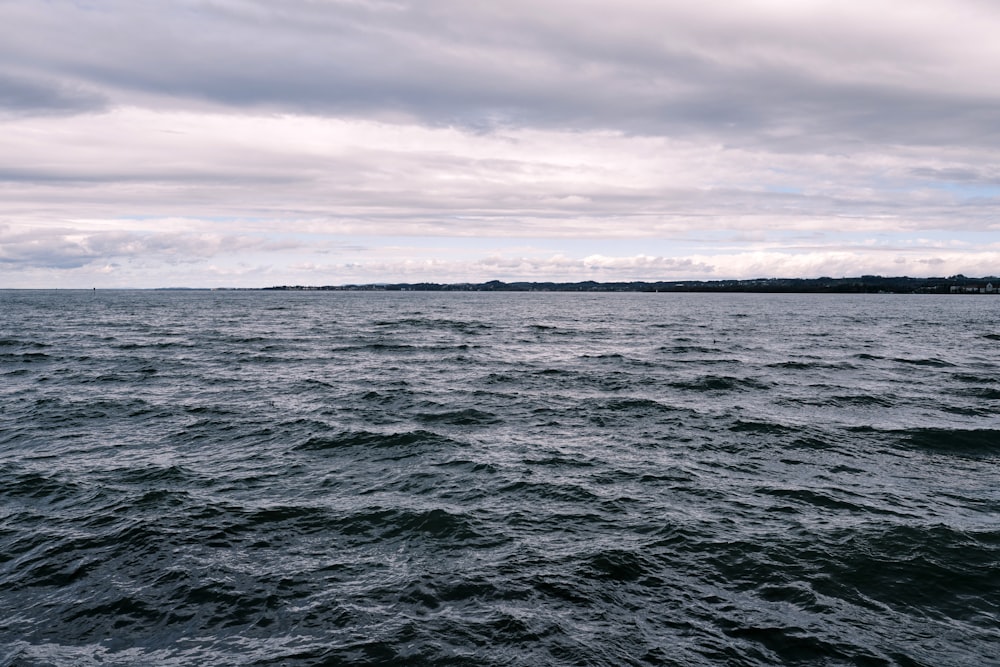 ocean under cloudy sky during daytime