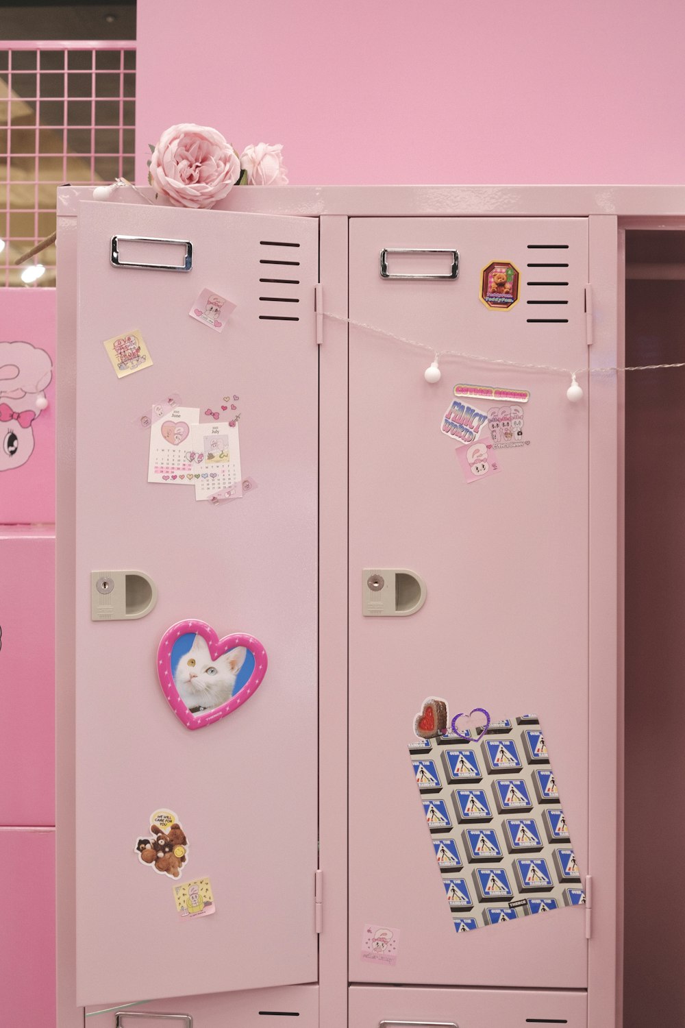 pink and white cabinet with stickers