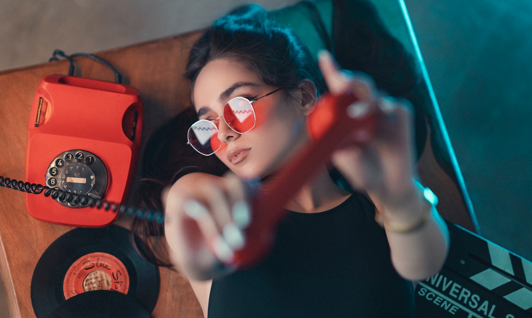 woman in black crew neck shirt holding red guitar