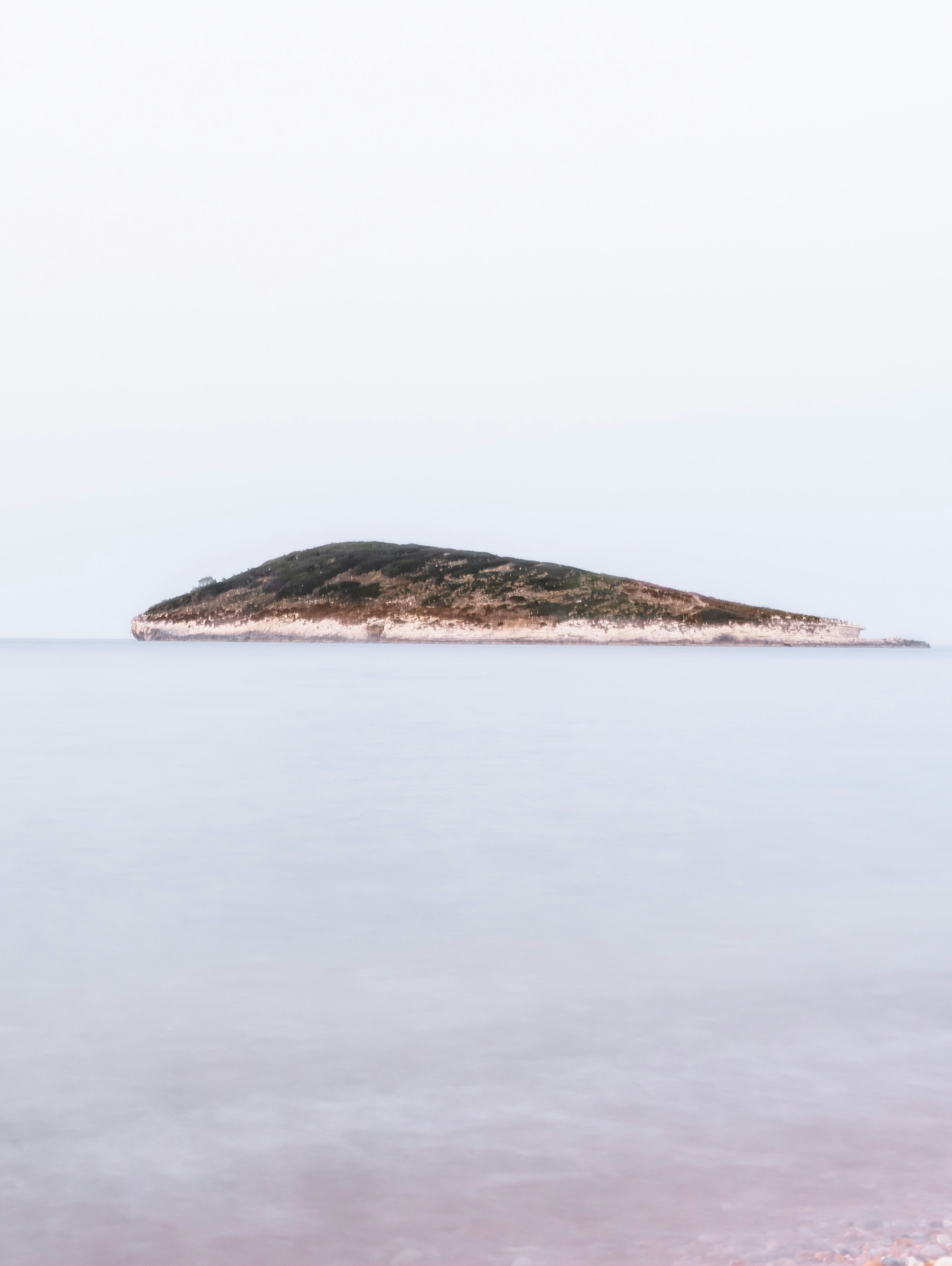 brown island on body of water