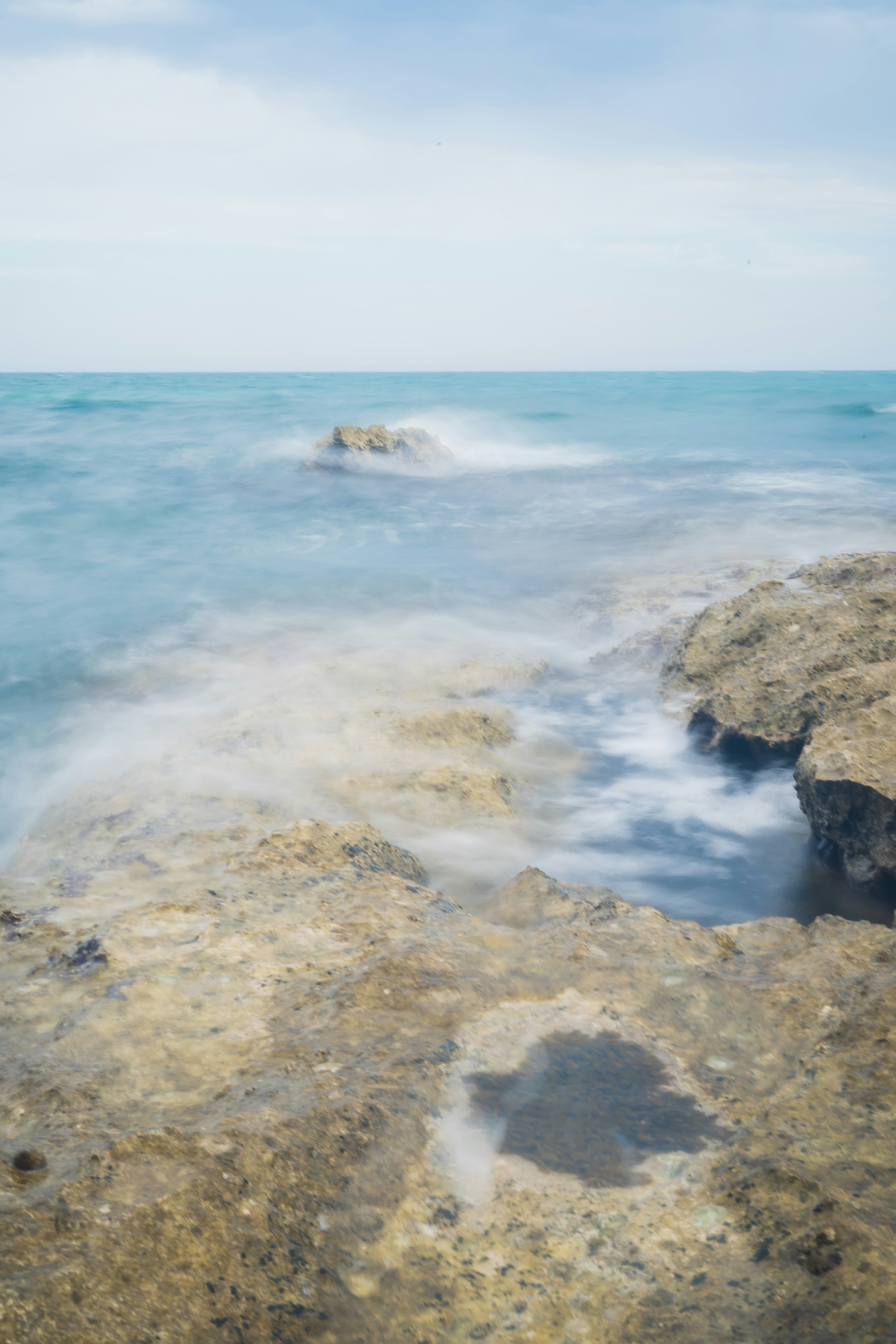 rocky shore with ocean waves during daytime