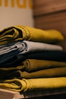gray and yellow textile on brown wooden table