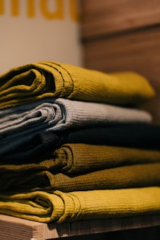 gray and yellow textile on brown wooden table