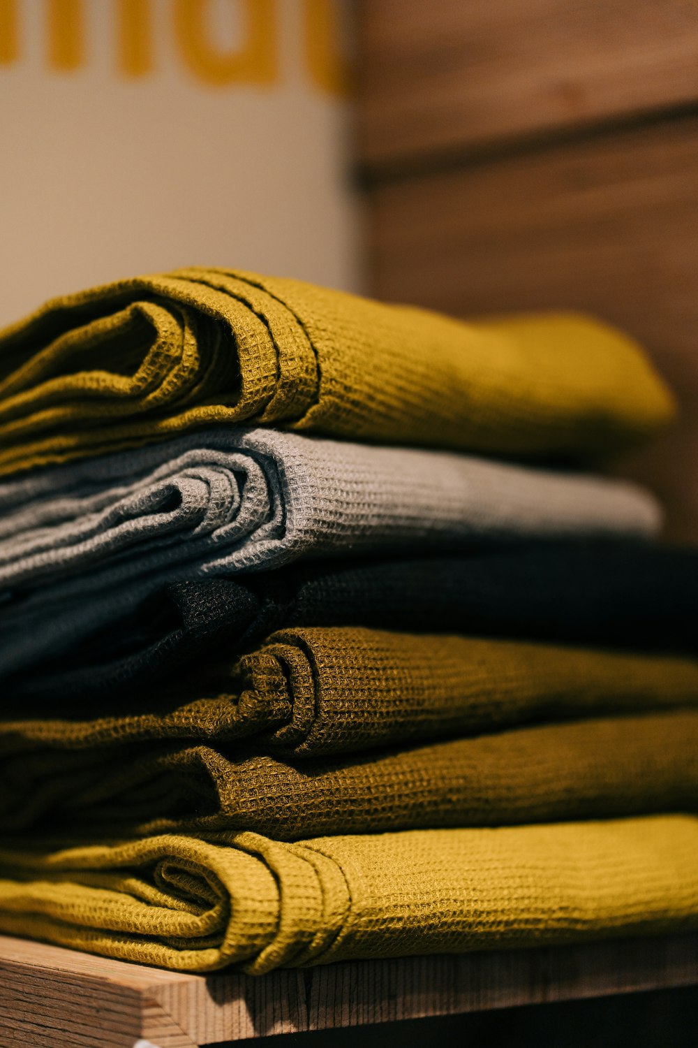 gray and yellow textile on brown wooden table