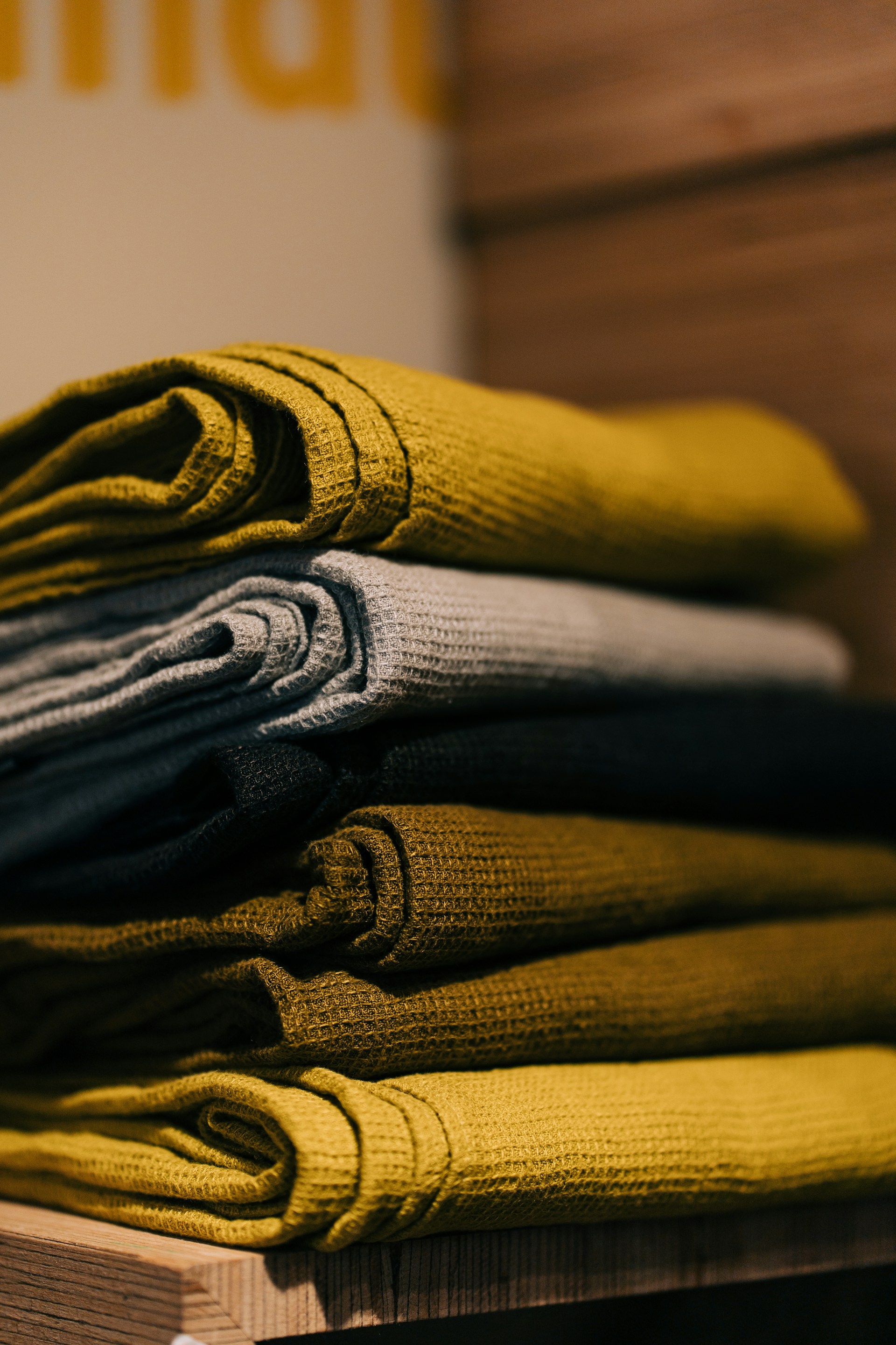 gray and yellow textile on brown wooden table