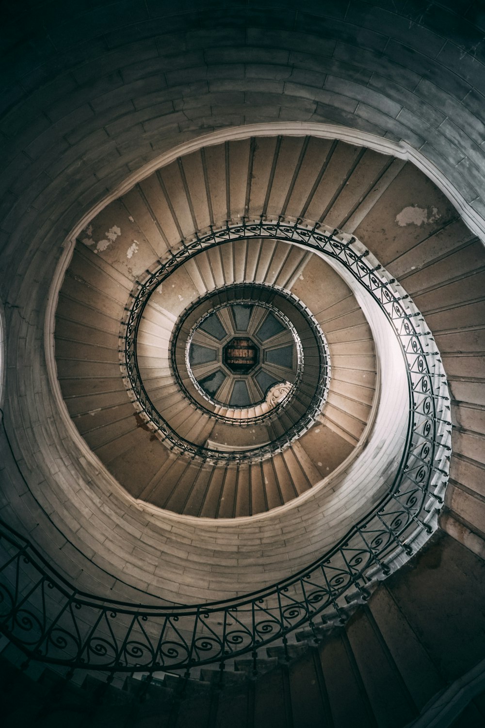 brown spiral staircase with brown wooden railings