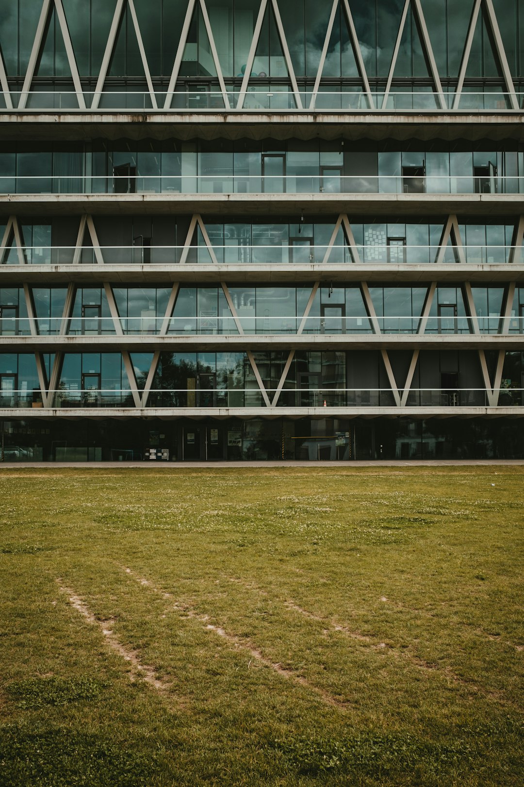 green grass field near white building