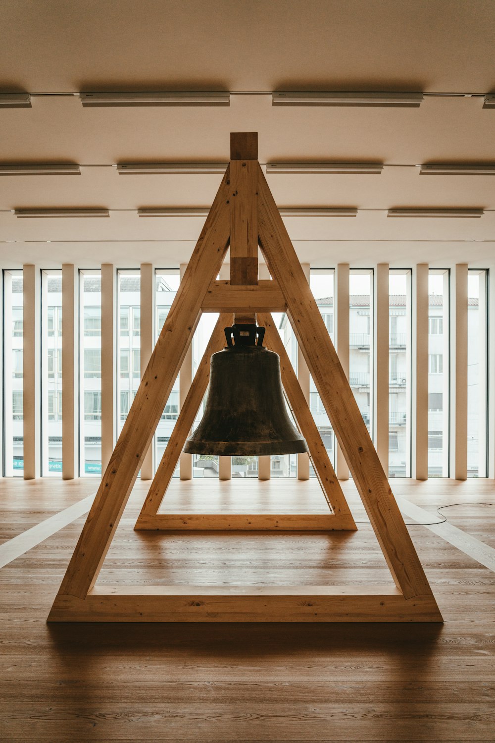 black bell on brown wooden stand