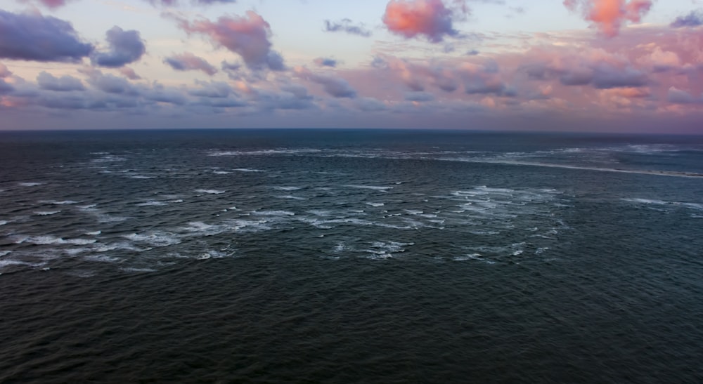 body of water under cloudy sky during daytime