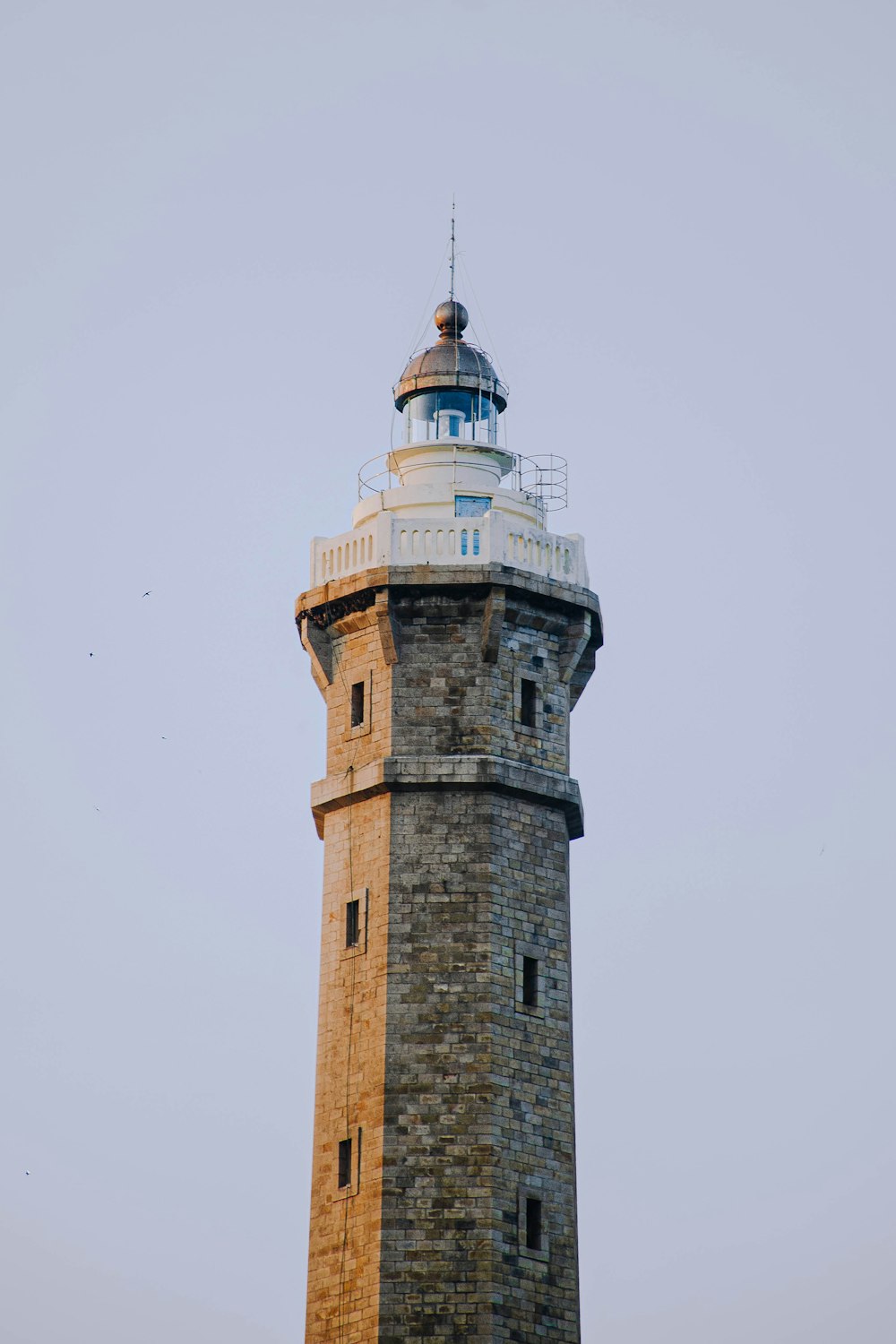 brown brick tower under white sky