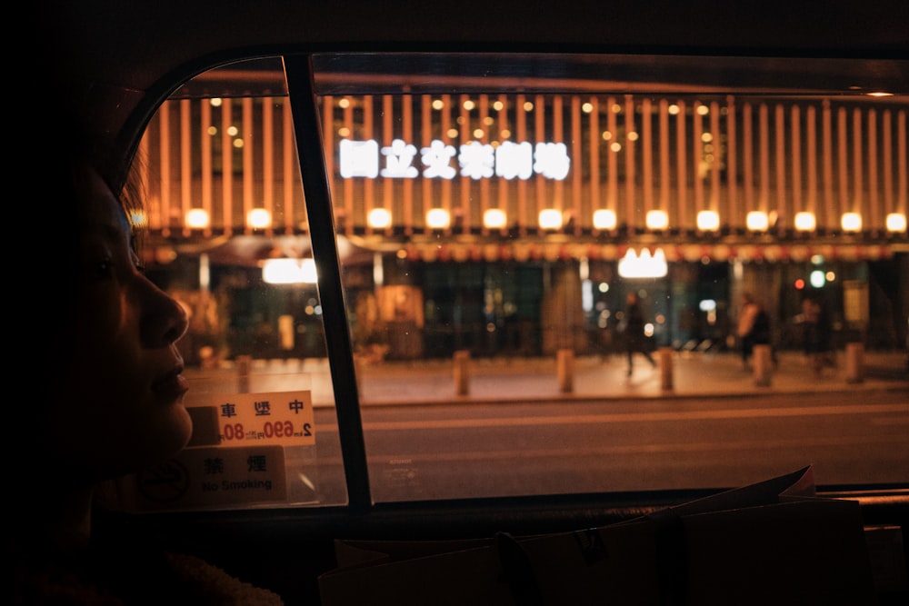 people sitting on chair near window during night time