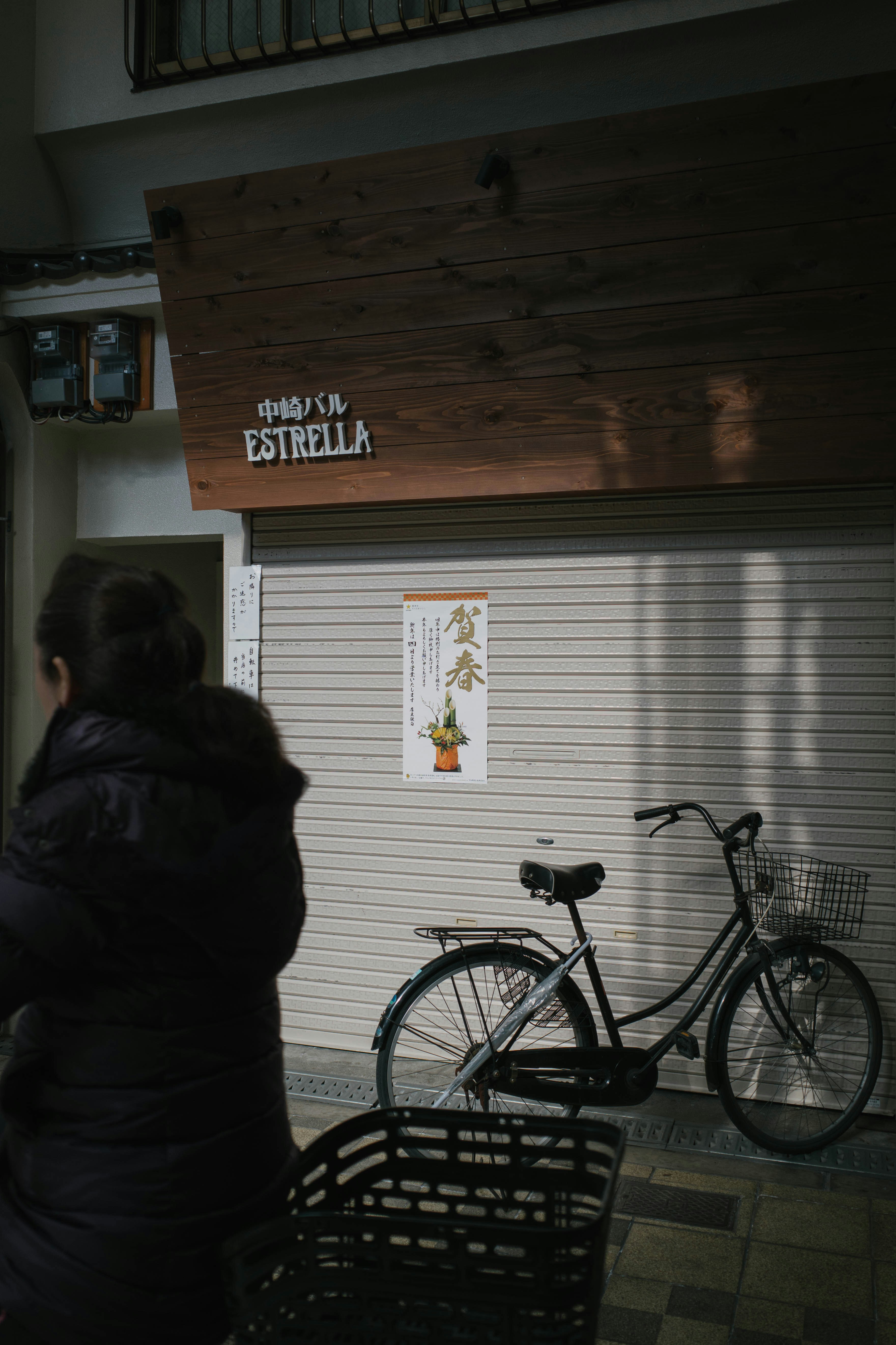 woman in black jacket sitting on black bicycle