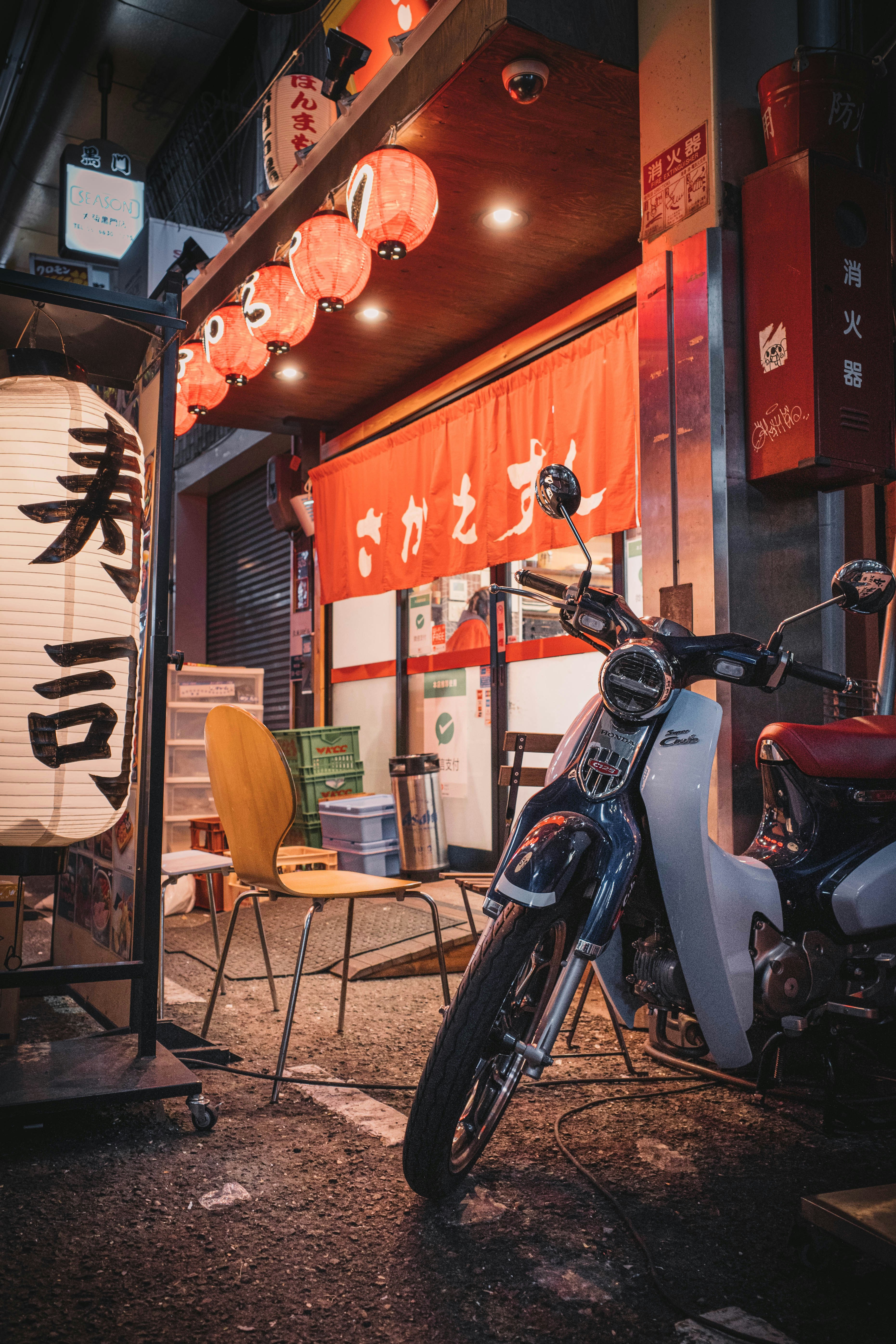 black and red motorcycle parked beside brown wooden chair