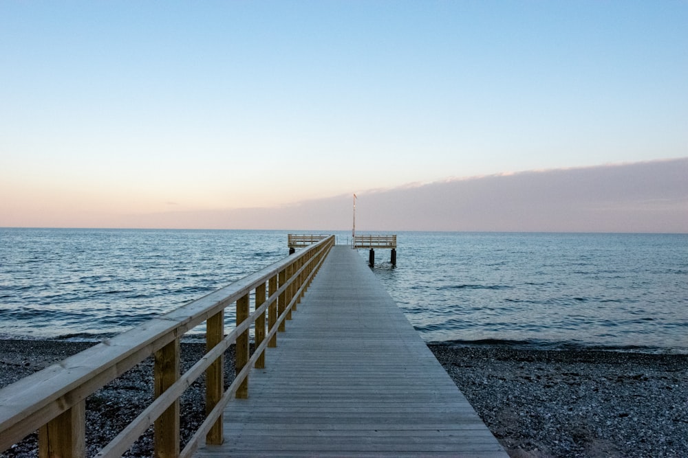 brown wooden dock on sea during daytime