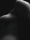 an abstract composition of light and shadow on a smooth bone-colored surface