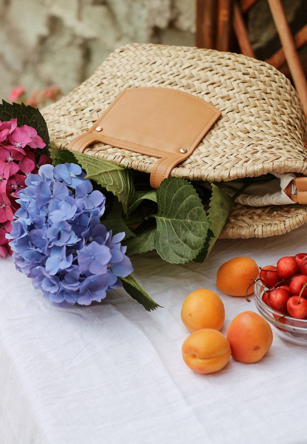 brown woven basket with orange and purple flowers