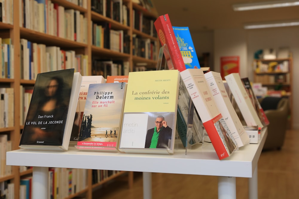 assorted books on white wooden shelf