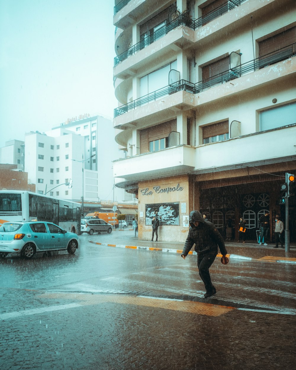 man in black jacket walking on sidewalk during daytime