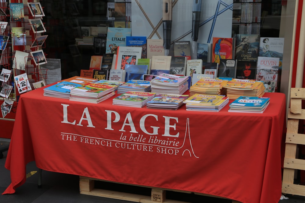 a table with books on it in front of a store