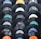 A collection of vintage vinyl records displayed in a pattern. Each record shows a different label from various recording companies such as Columbia, Decca, and Philips. The records have a glossy black finish and the labels feature a mix of colors including blue, orange, and white.