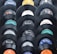 A collection of vintage vinyl records displayed in a pattern. Each record shows a different label from various recording companies such as Columbia, Decca, and Philips. The records have a glossy black finish and the labels feature a mix of colors including blue, orange, and white.