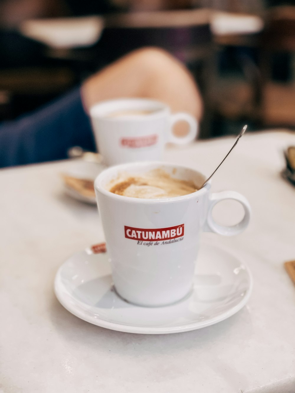 white ceramic cup on white ceramic saucer