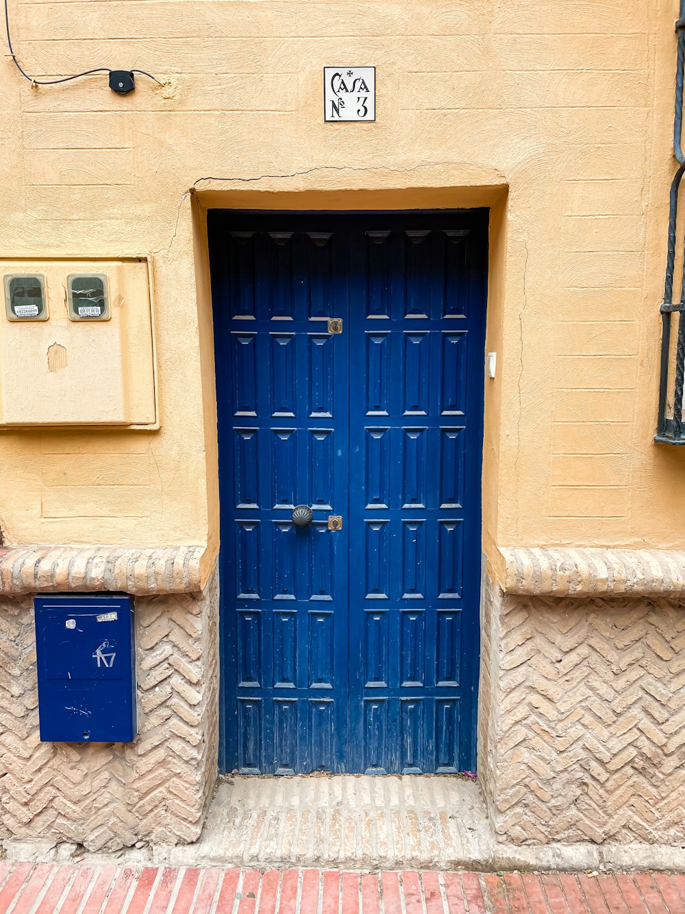 blue wooden door on beige concrete building