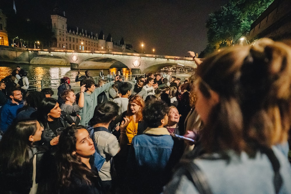 a crowd of people standing next to each other