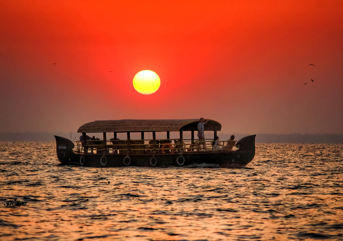 The silhouette of a boat on Kerala water at sunset