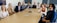 A friendly property manager discussing with a group of people in a meeting room.
