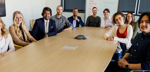 group of people sitting on chair in front of brown wooden table