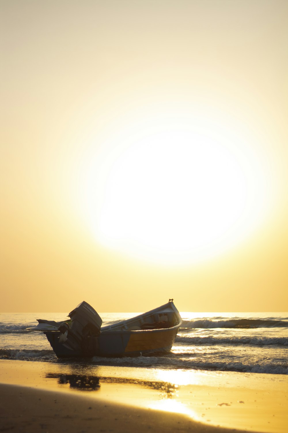 brown boat on beach during sunset