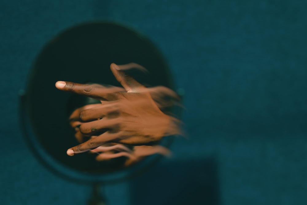 persons hand on blue textile