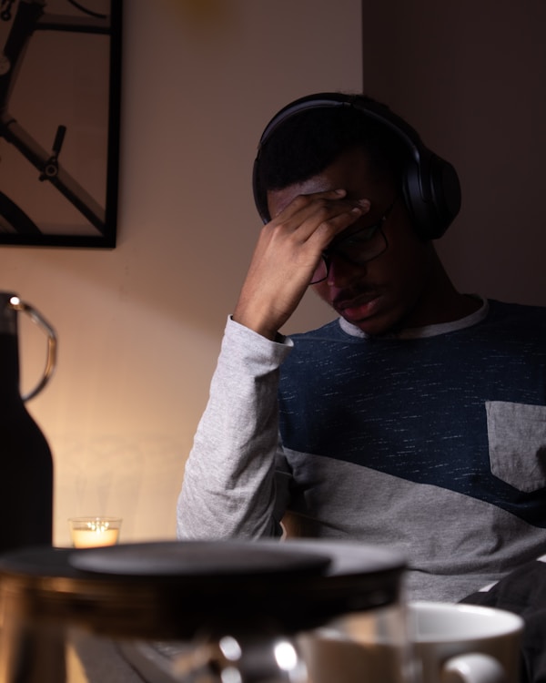 woman in gray sweater covering her faceby Nubelson Fernandes