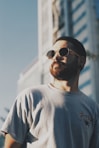 man in white crew neck shirt wearing black sunglasses
