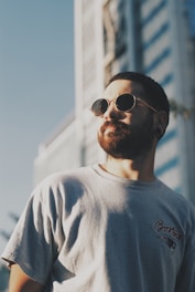 man in white crew neck shirt wearing black sunglasses
