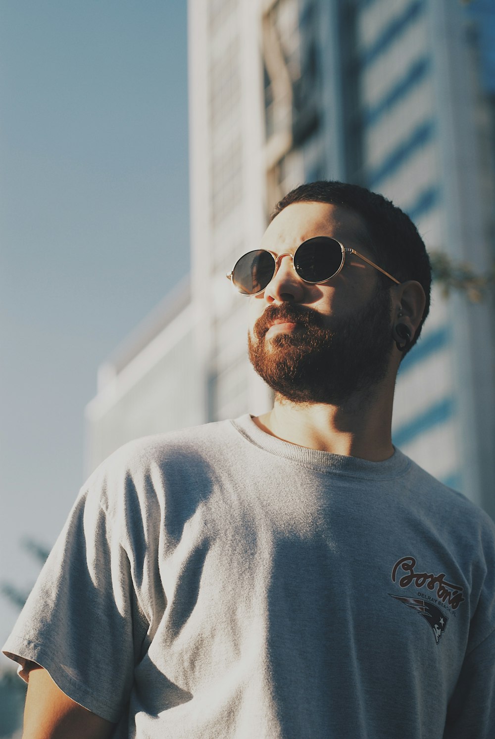 man in white crew neck shirt wearing black sunglasses