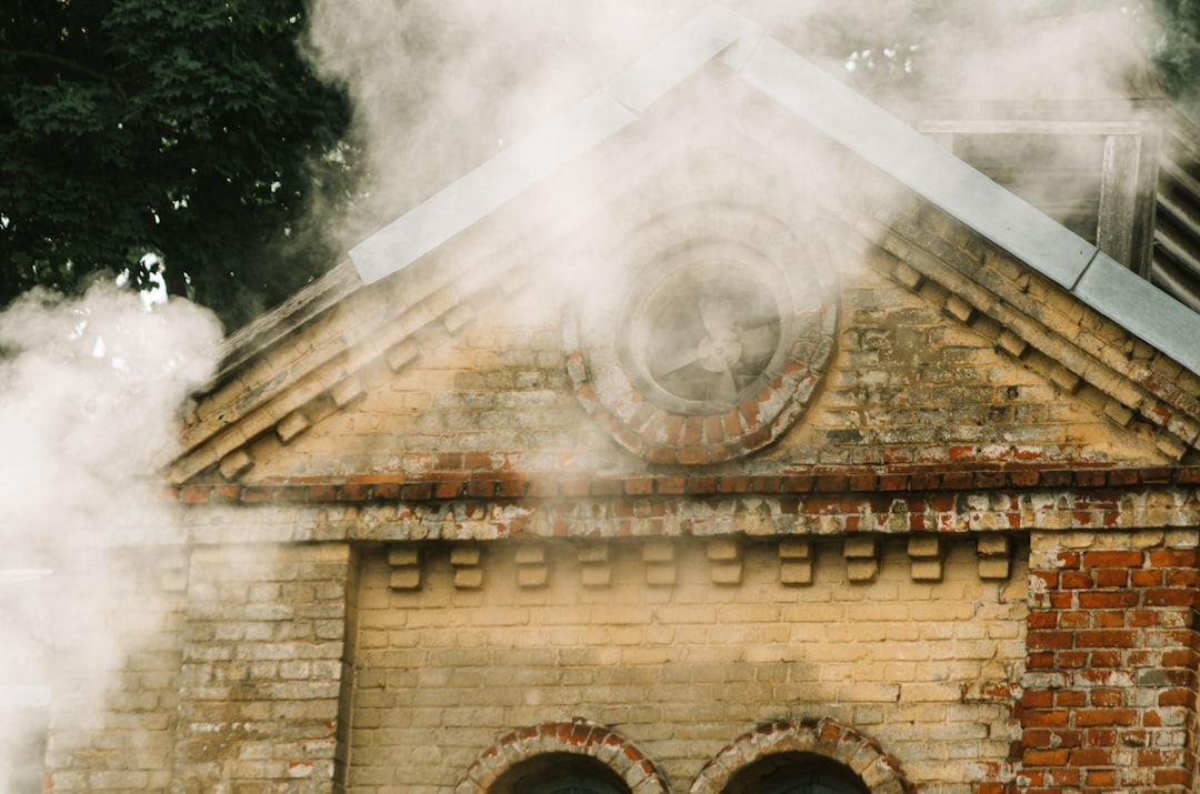 brown brick building with smoke