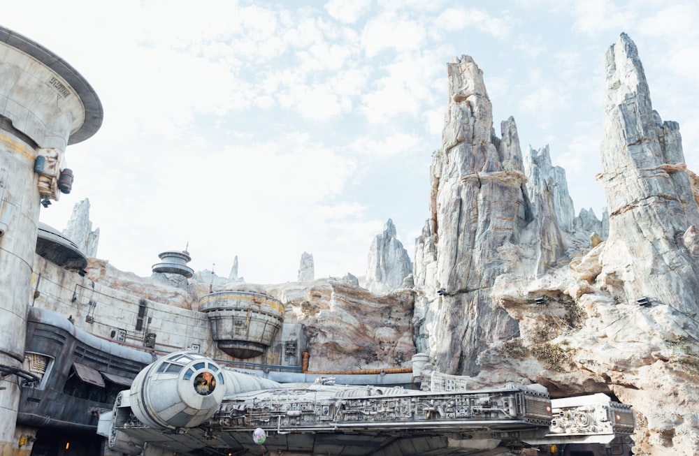 gray and black space ship on top of gray rock formation during daytime