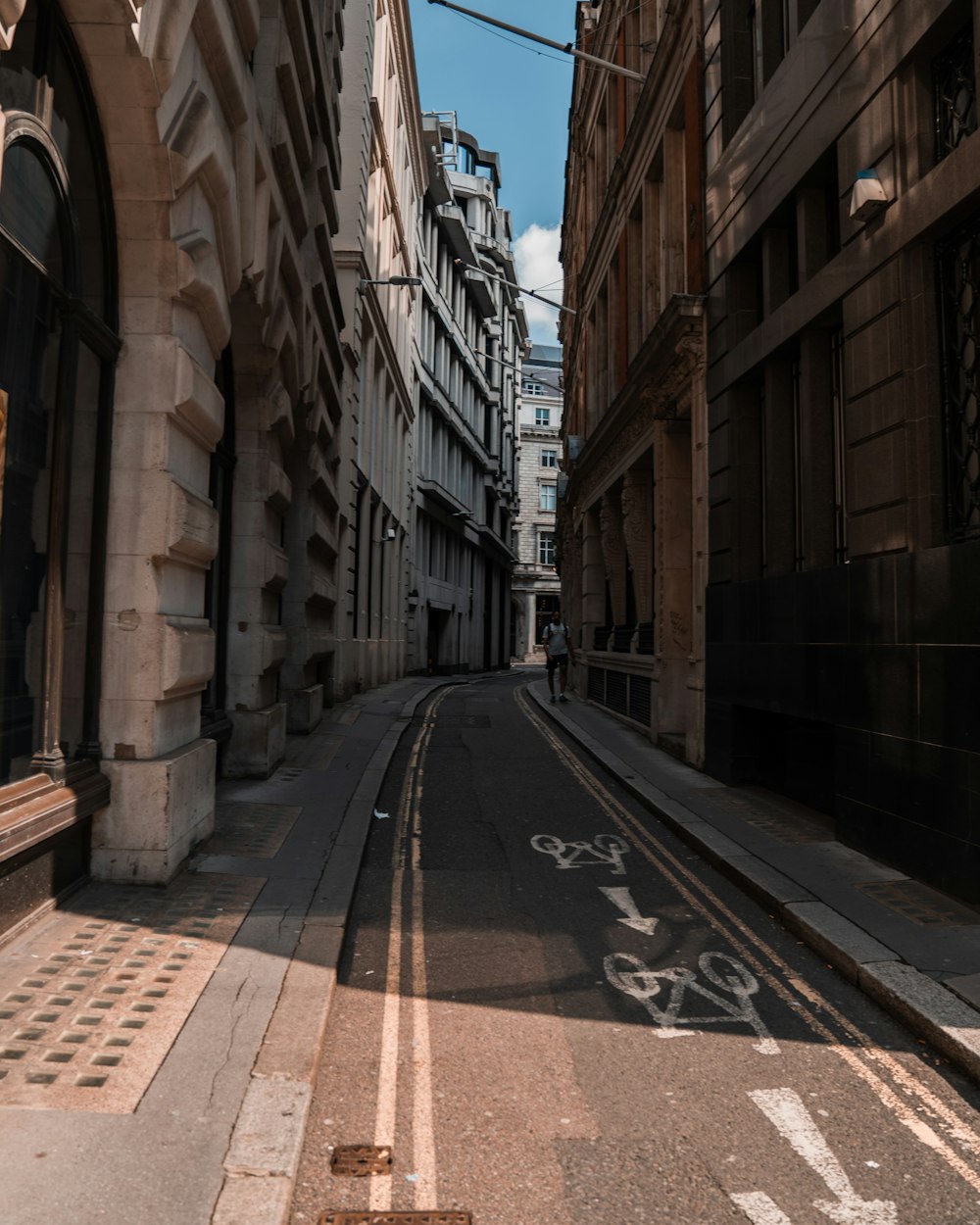 empty road between concrete buildings during daytime