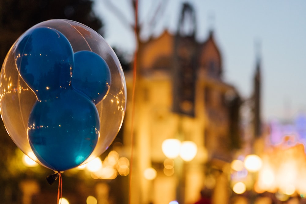 blue balloon in the middle of the city during night time