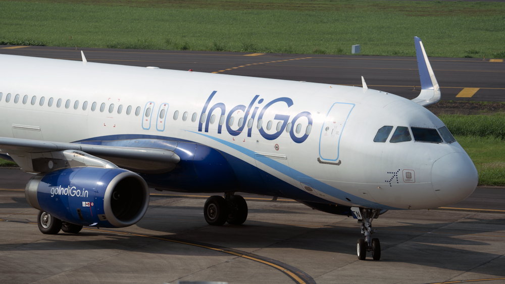 white and blue airplane on airport during daytime