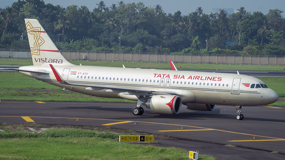 white and red passenger plane on airport during daytime