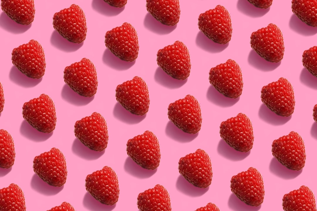 red raspberries on white surface