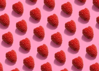 red raspberries on white surface