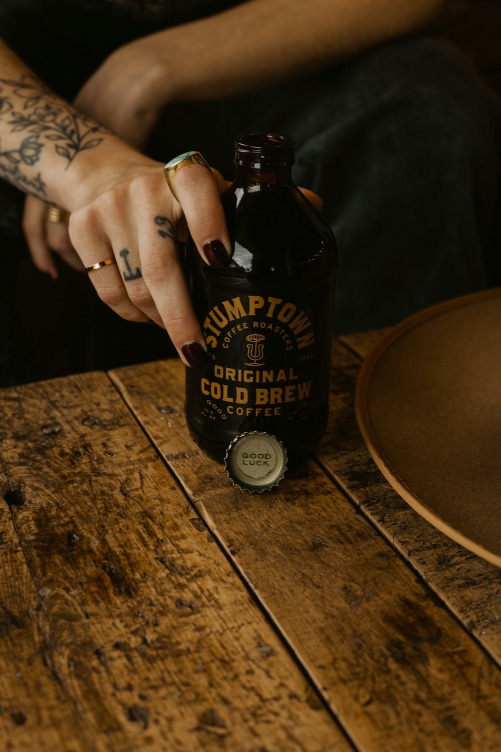 person holding black glass bottle