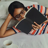 A cozy scene with someone wearing stylish reading glasses while sipping coffee.