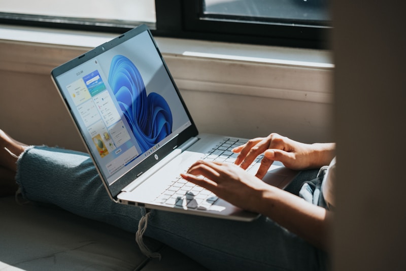 person using macbook pro on lap