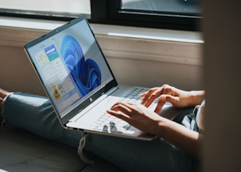 person using Windows 11 computer on lap